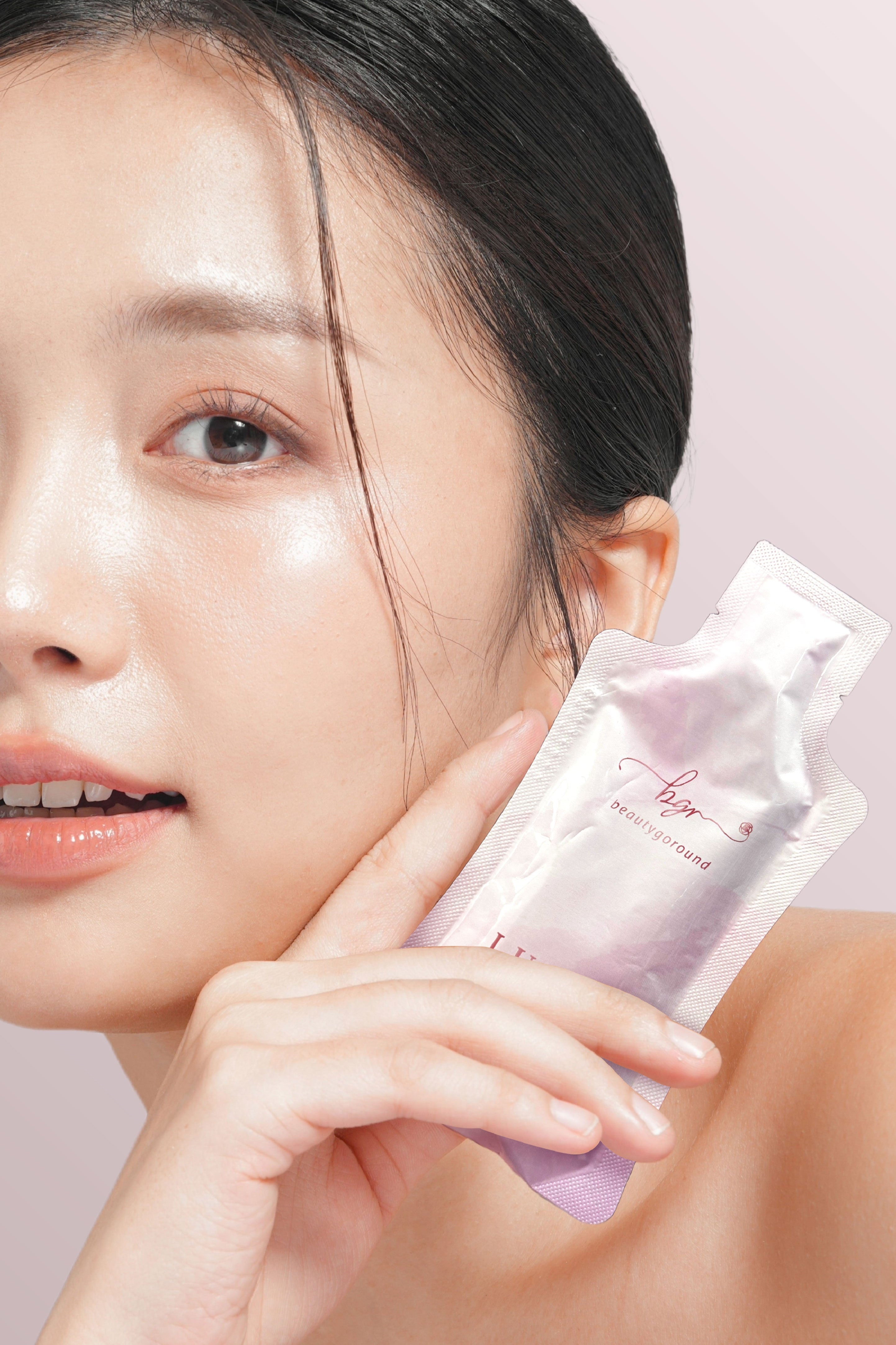 Woman holding a beauty supplement product Lustre White NMN Beauty Shot